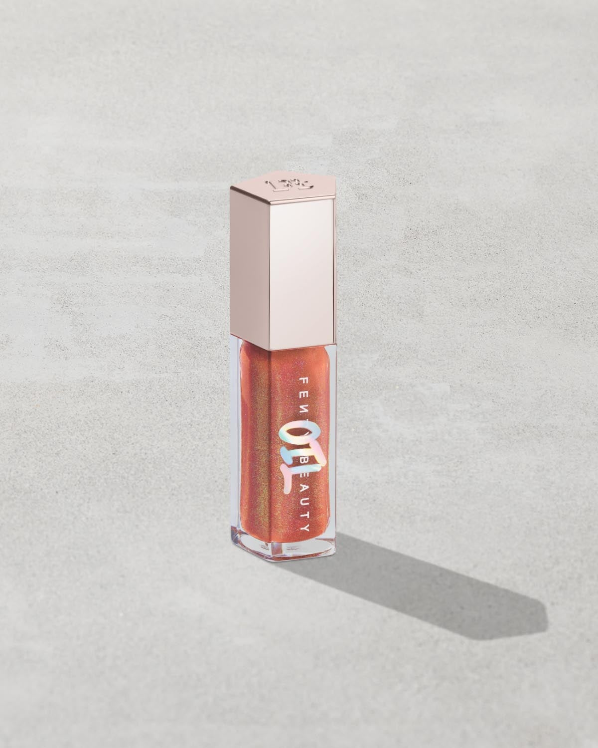 FB_SMR25_T2PRODUCT_ECOMM_GB-OIL_FENTY-GLOW_1200X1500_72DPI.jpg Gloss Bomb Oil Luminizing Lip Oil 'N Gloss - Fenty Glow - Image 1